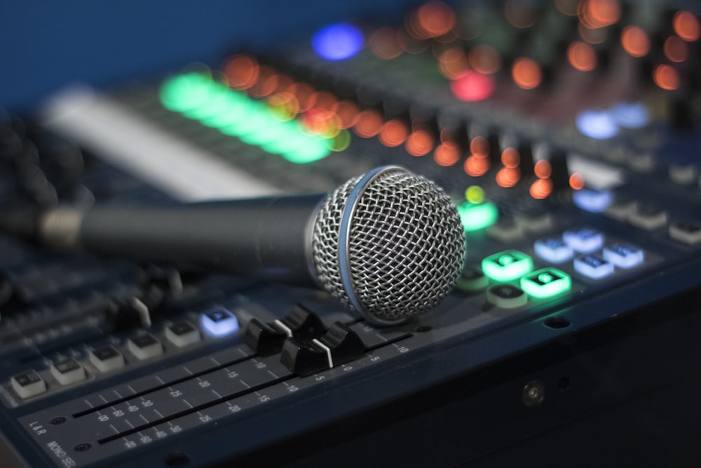 A microphone on a sound board

Description automatically generated